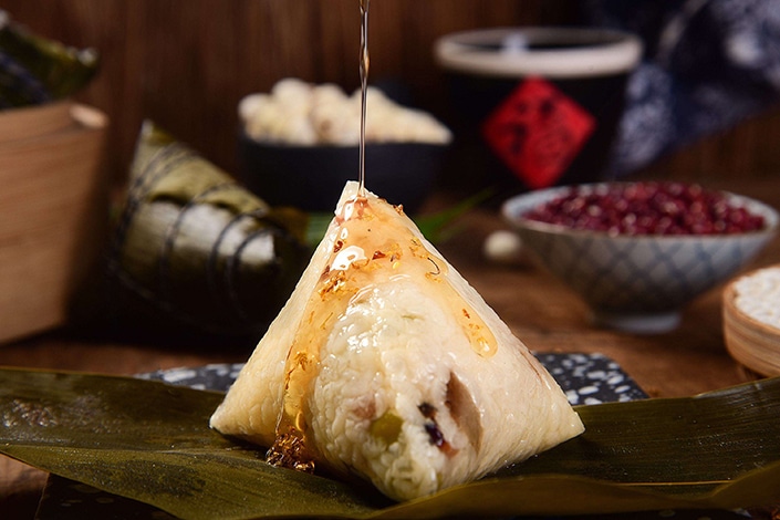Chinese people making zongzi to celebrate the dragon boat festival