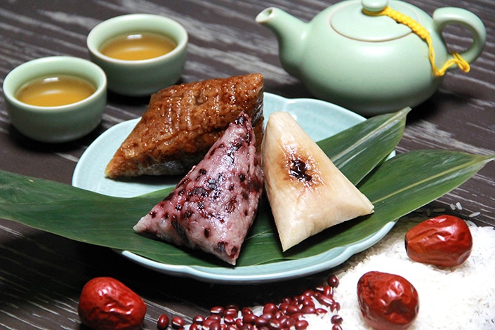 Chinese people making zongzi to celebrate the dragon boat festival