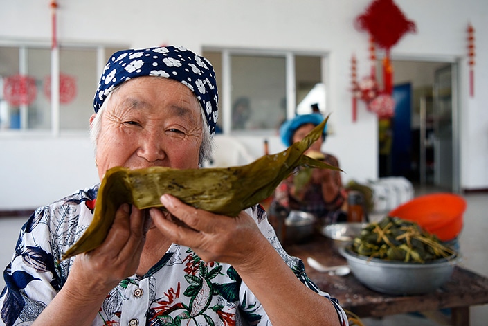 Chinese people making zongzi to celebrate the dragon boat festival
