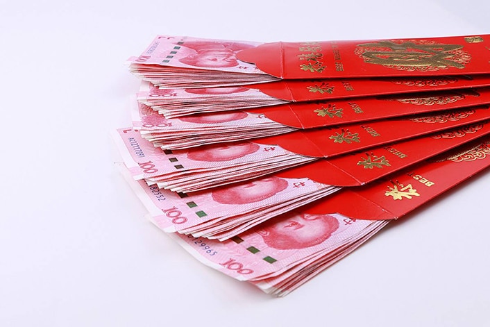 A stack of Chinese red envelopes containing an auspicious amount of money in accordance with Chinese numerology