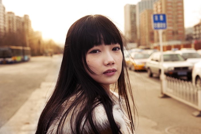 a photo of young Chinese woman who embodies standards of beauty in China looking back at the viewer