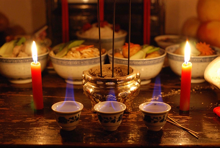 offerings to the ancestors sit on a table