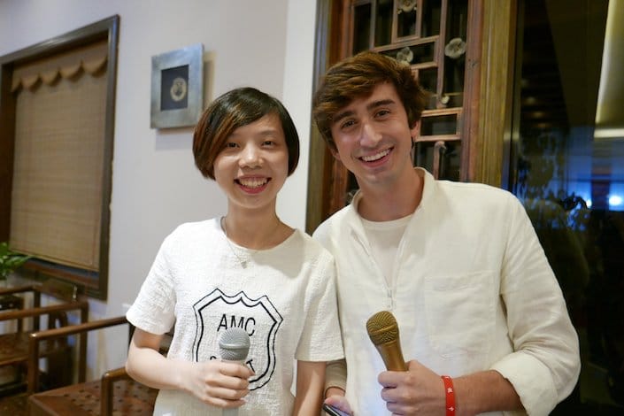 a CLI student and teacher holding microphones getting ready to record Chinese podcasts