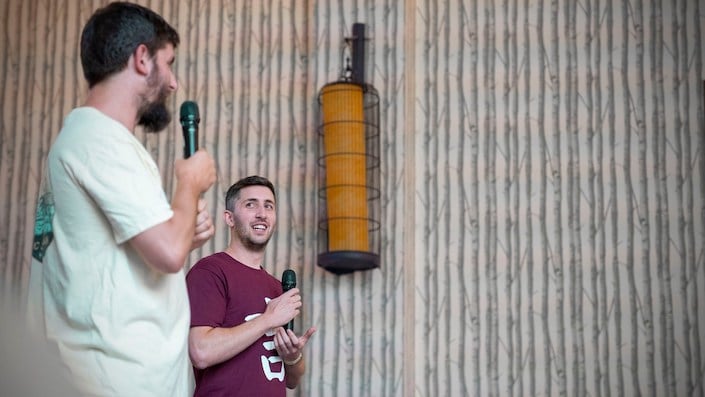 CLI founders holding microphones and getting ready to record Chinese podcasts