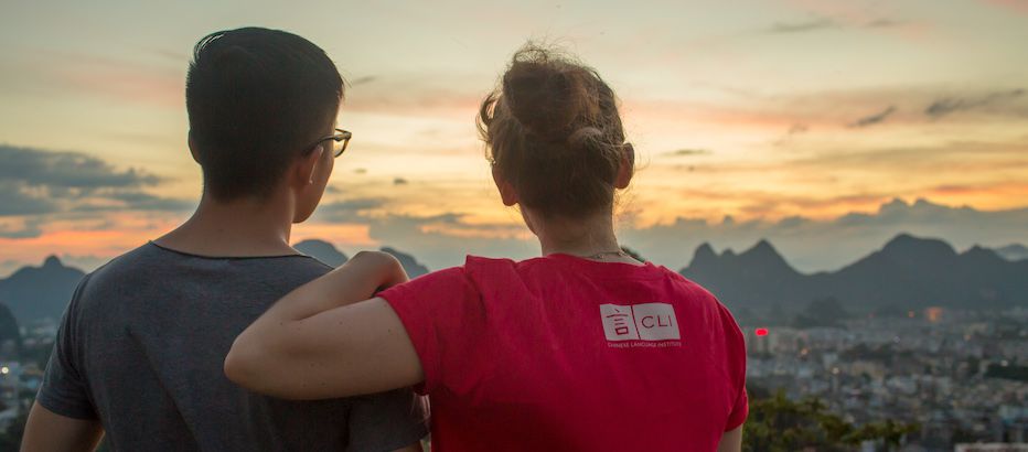 CLI staff members stare towards distant mountains at dusk