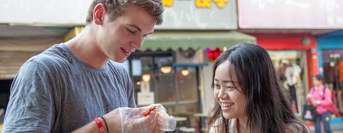 Young man and women eating food in China