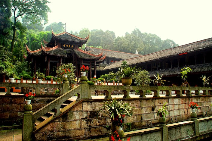 chinese buddhist temple with assortment of planters in front