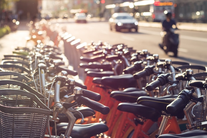 a row of shared bicycles sitting beside a road in China